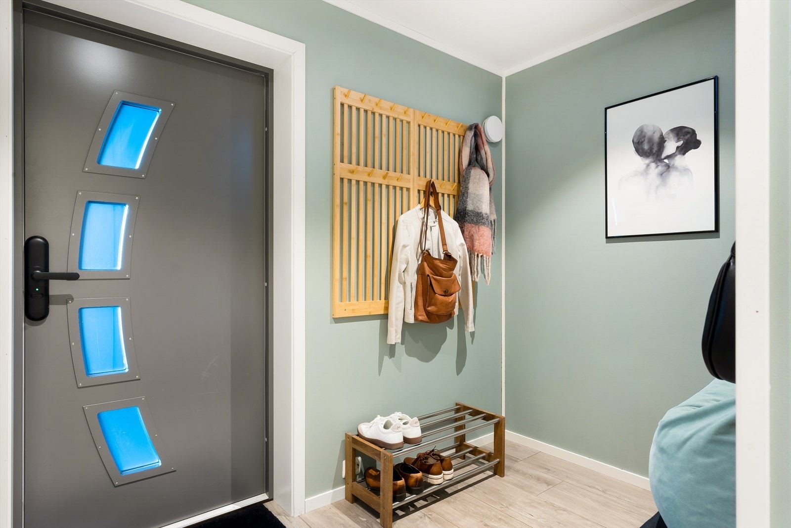 Fra et pent, overbygd inngangsparti kommer du inn i en lys og praktisk entré. Galleribilde