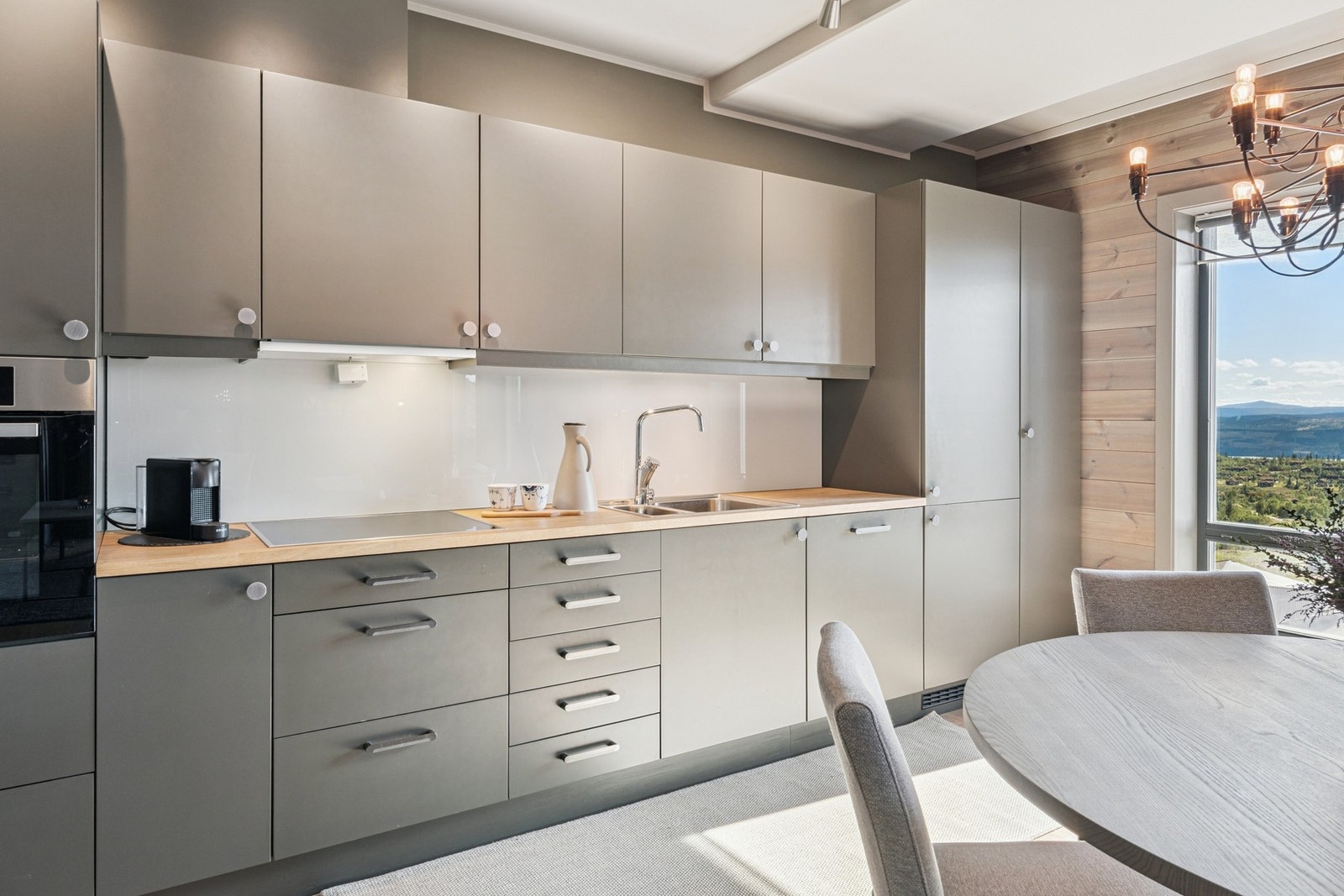 Moderne kjøkkeninnredning med glatte fronter og integrerte hvitevarer. Galleribilde