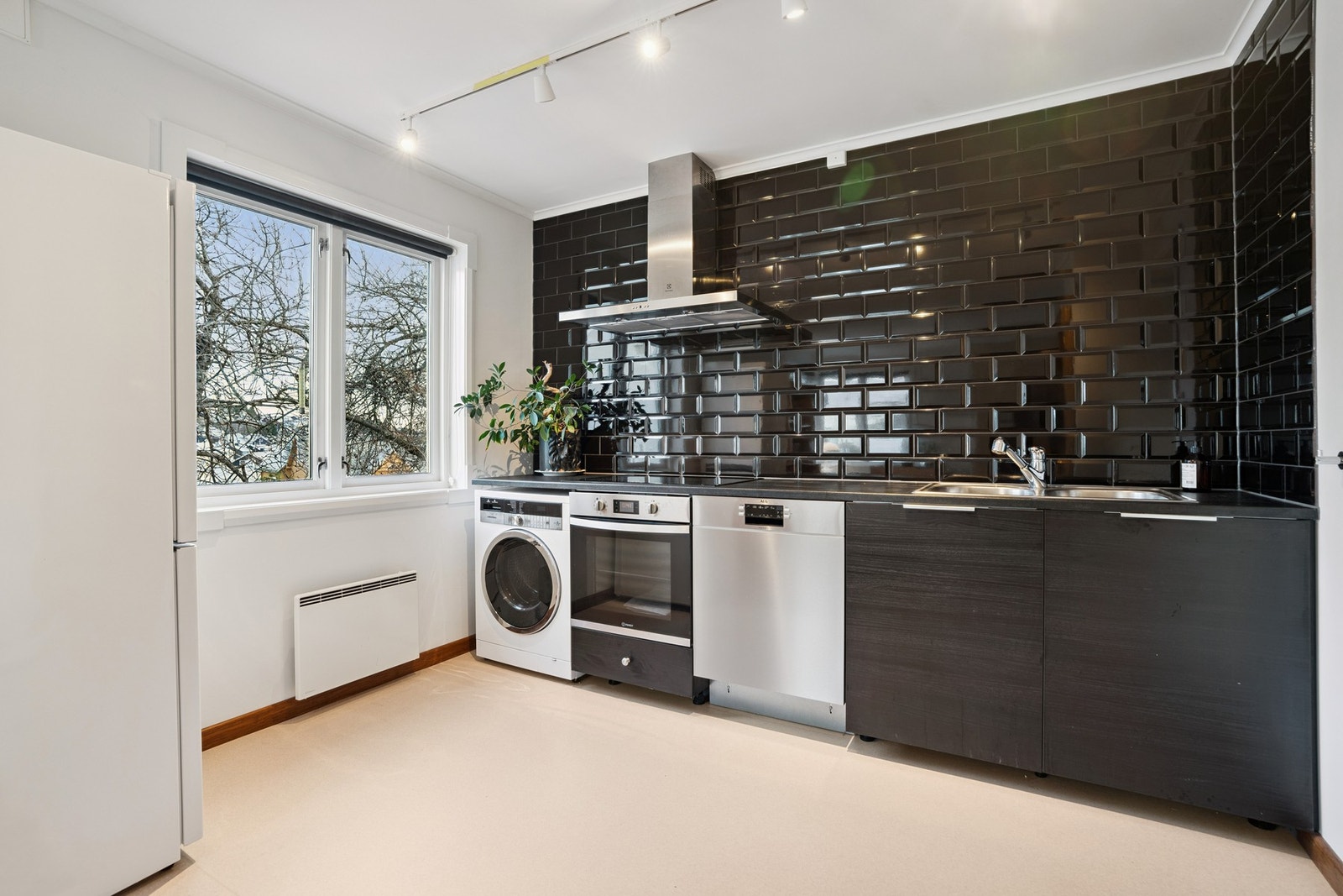 Vaskerommet har vaskemaskin, komfyr og oppvaskmaskin Galleribilde