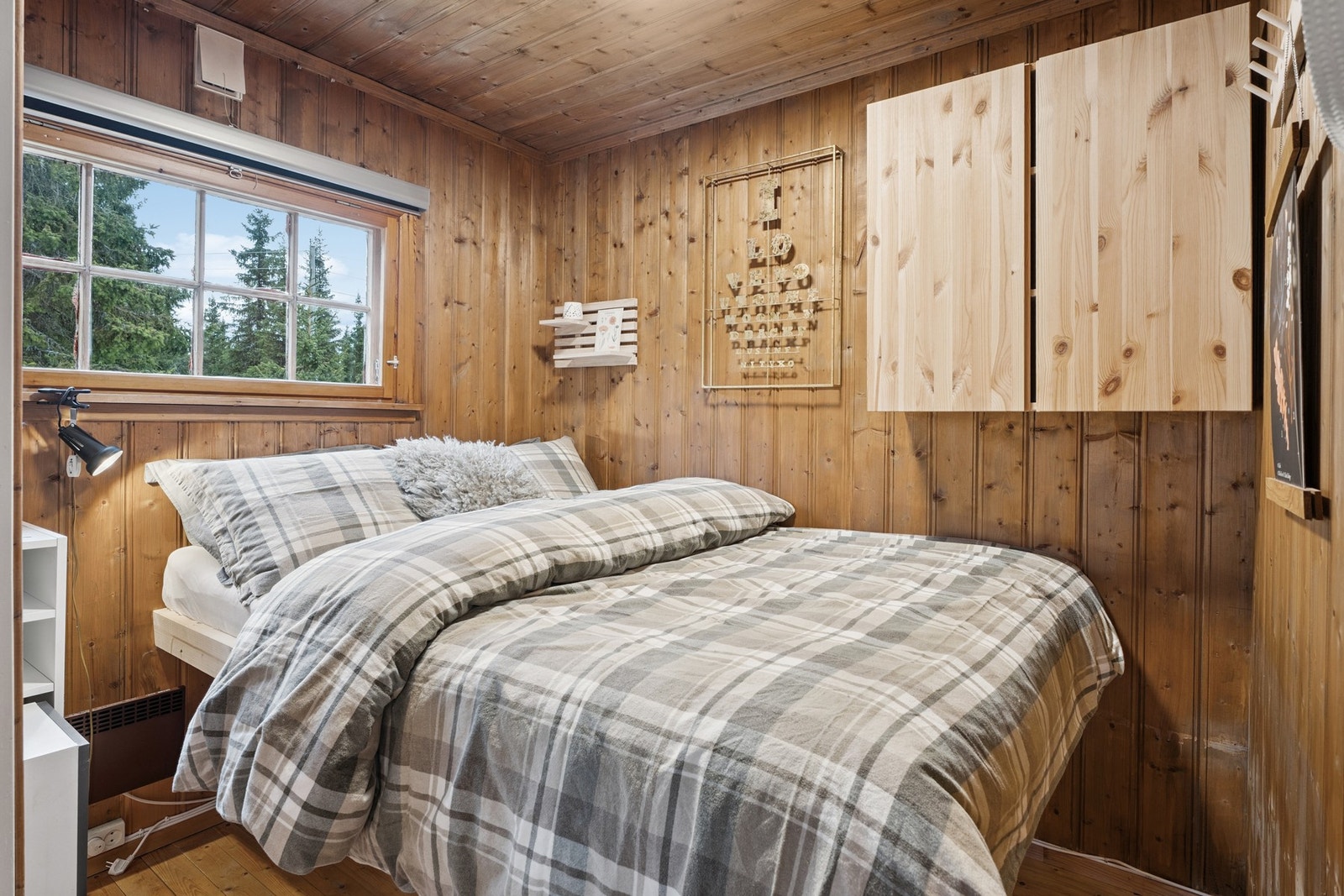 Soverom innredet med plassbygd dobbeltseng med oppbevaringsplass under, med vegger beiset i en lun farge. Det gjøres oppmerksom på at på grunn av størrelse, oppfyller ikke rommet anbefalt størrelse til soverom. Galleribilde