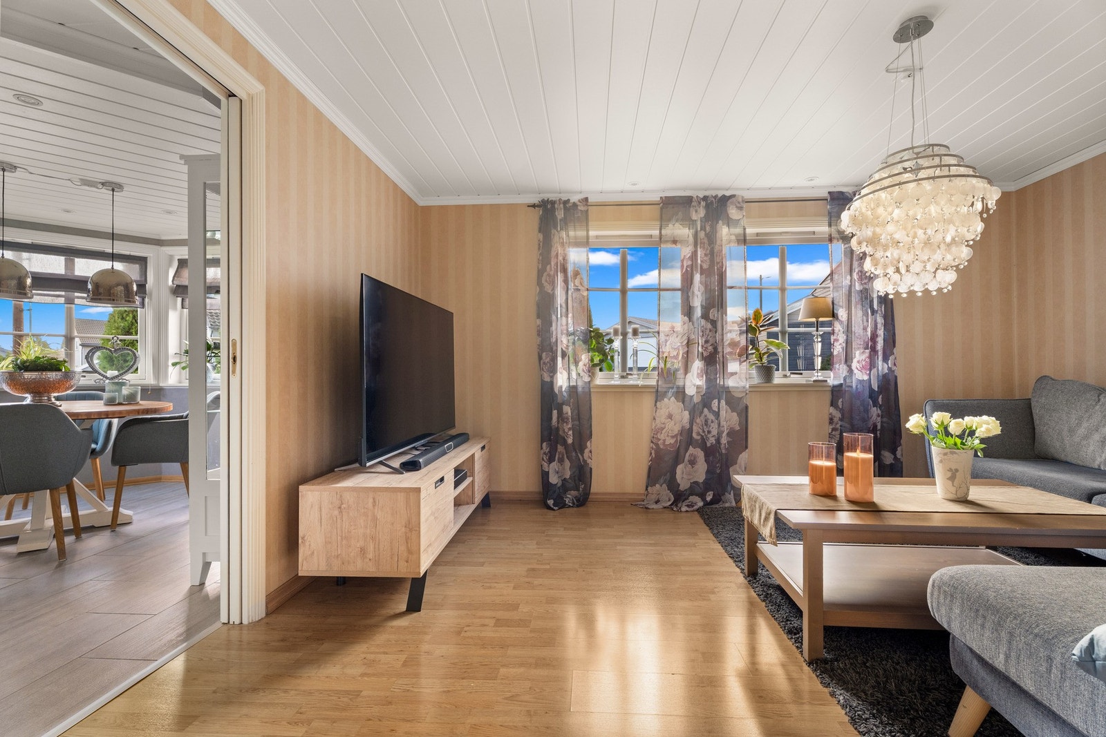 Tv-stuen med laminat på gulv og tapet på vegger Galleribilde