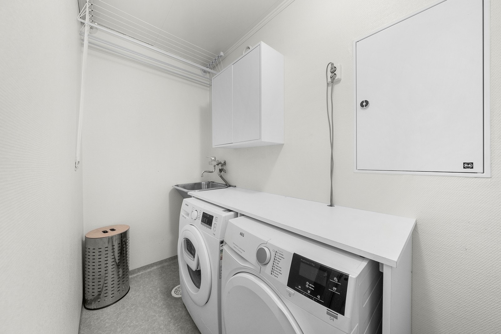 Opplegg for vaskemaskin og tørketrommel og det er montert en utslagsvask. Avtrekk er montert. Galleribilde