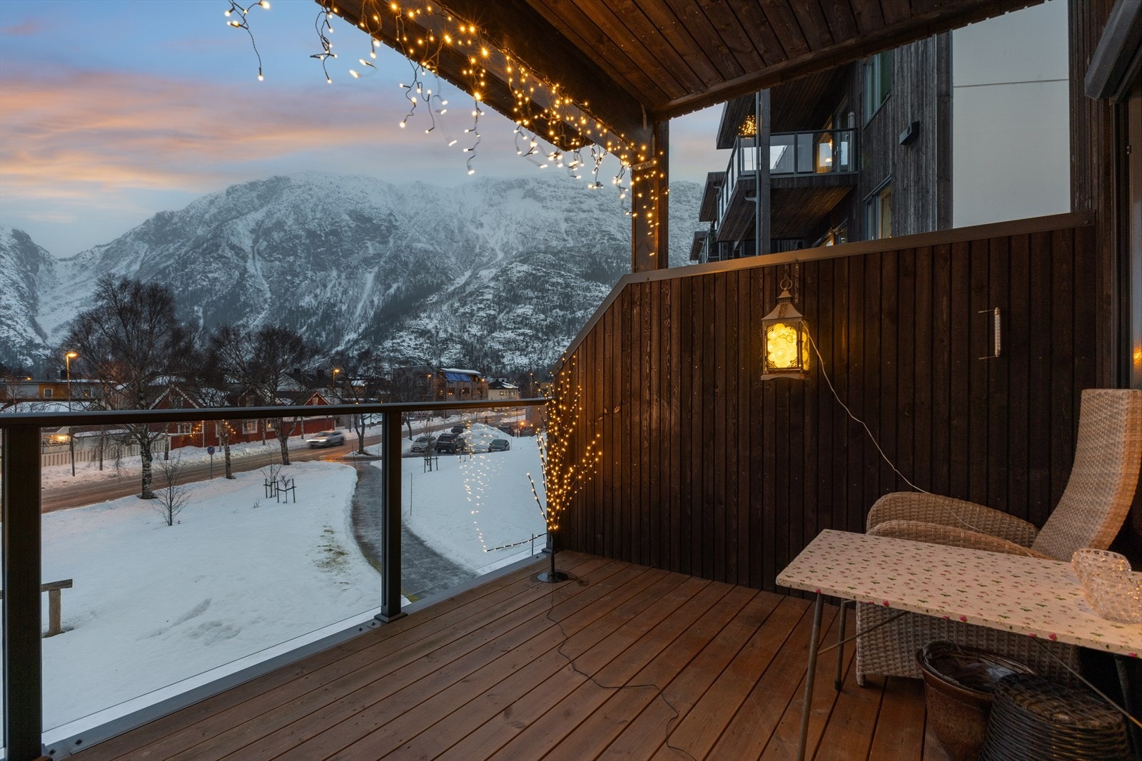 Altan på ca. 11 m² med rekkverk av glass og metall gir utsikt mot fjellandskapet. Rekkverkshøyden er oppgitt til å være 99 cm, noe som bør justeres for å møte dagens krav. Galleribilde