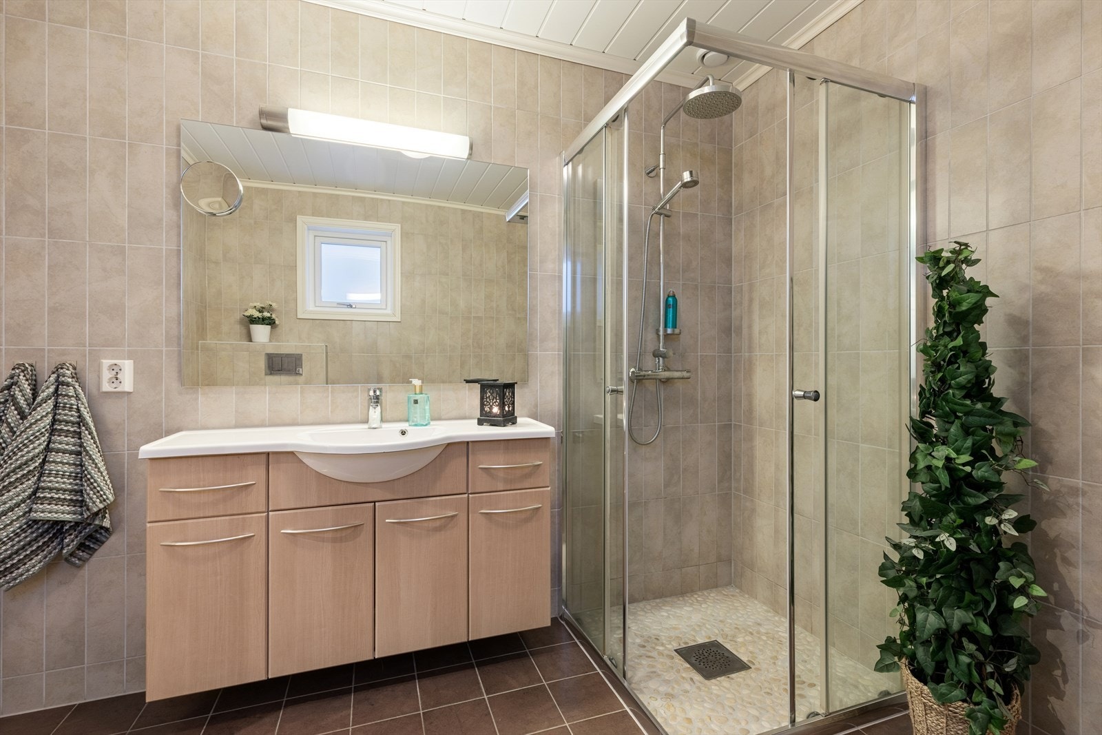 Flislagt baderom med god størrelse, med toalett, dusjhjørne og innredning, samt mulighet for å sette inn badekar. Galleribilde