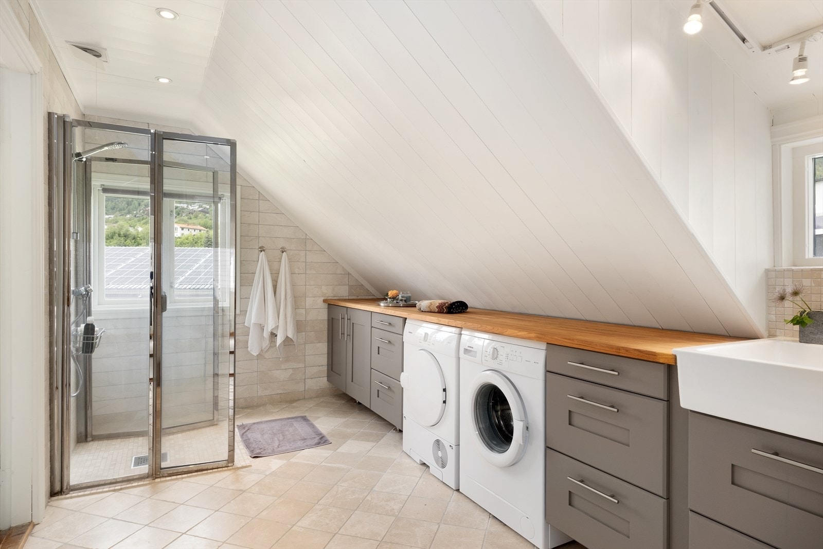 Badet er innreia med dusjplass med glasdører,servant som er bygd inn i del av innredning. Det er opplegg for vaskemaskin og gode oppbevaringsmoglegheiter. Galleribilde