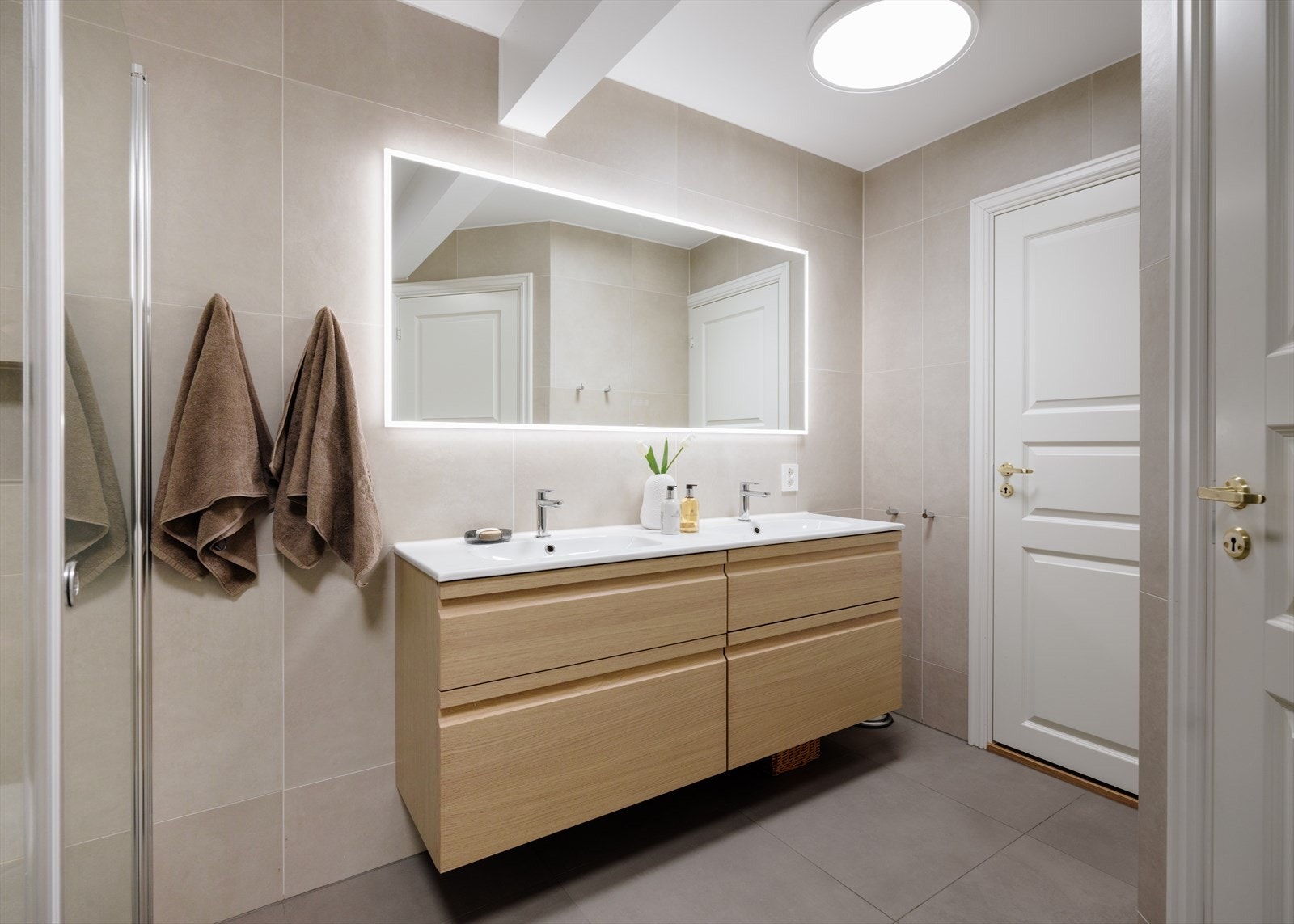 Moderne skapinnredning med to nedfelte servanter og god oppbevaringsplass Galleribilde