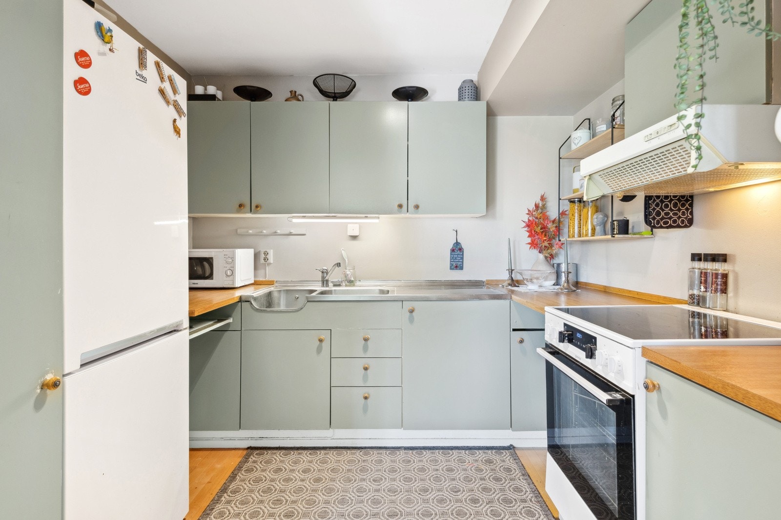 Det er avsatt plass til frittstående komfyr og kjøleskap i egen nisje og ventilator er plassert over kokesonen. Det er per i dag ikke opplegg for vaskemaskin på kjøkkenet. Galleribilde