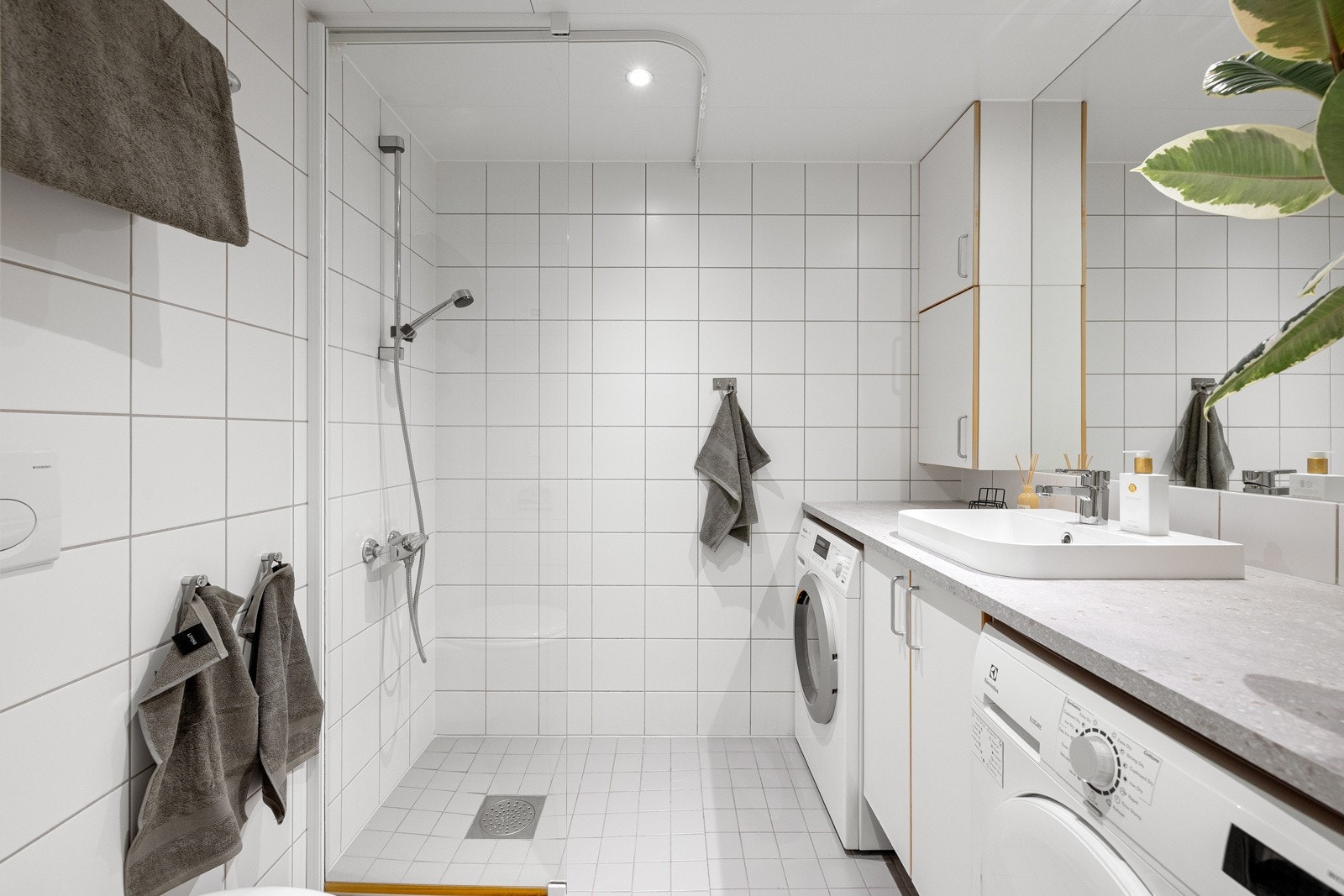 Tidløst bad med flislagte overflater, downlights og gulvvarme. Ny benkeplate, servant og servantbatteri høsten 2025. Galleribilde