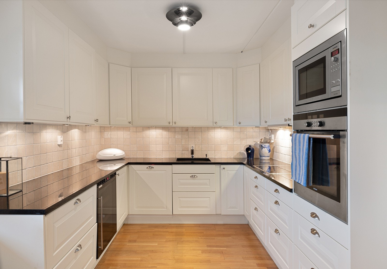 Det er montert en integrert oppvaskmaskin, integrert komfyr og nedfelt platetopp og det er tilkoblet en ventilator over kokeplass. Integrerte kjøleskuffer og mikrobølgeovn. Galleribilde