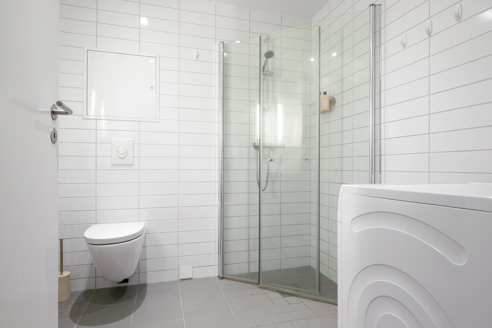 Badet er stilrent med flislagte overflater, gulvvarme, downlights og avtrekk via balansert ventilasjon Galleribilde