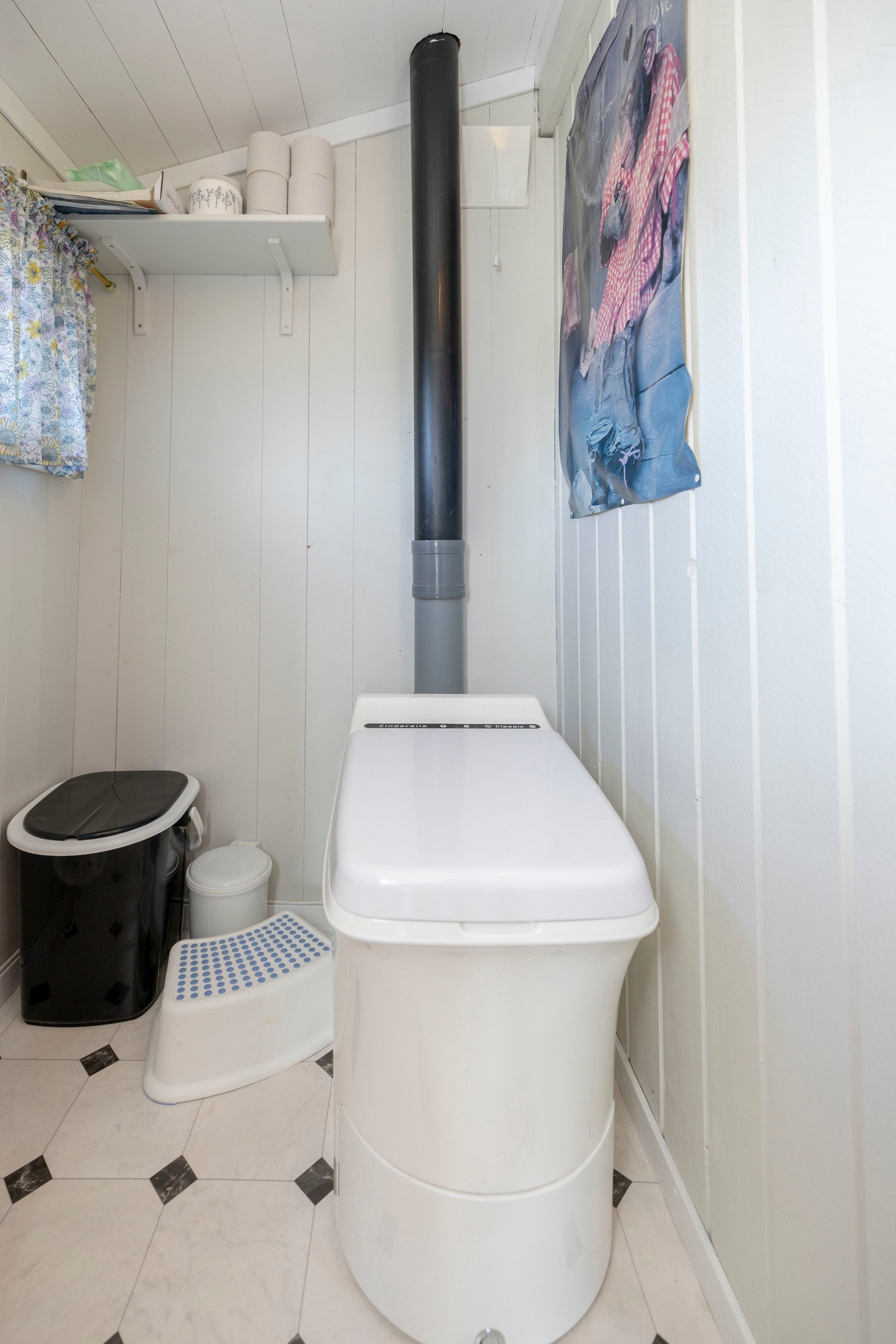 Praktisk toalettrom med gulvbelegg og malte panelflater på både vegger og himling, som gir et lyst og rent uttrykk. Galleribilde