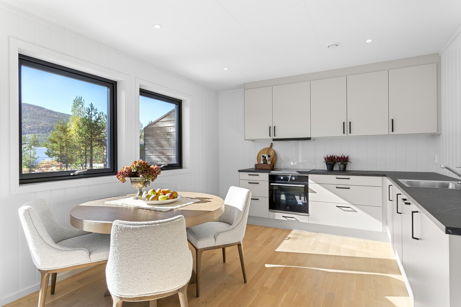 Funksjonelt og stilrent Sigdal-kjøkken med integrert komfyr, platetopp og oppvaskmaskin. Galleribilde