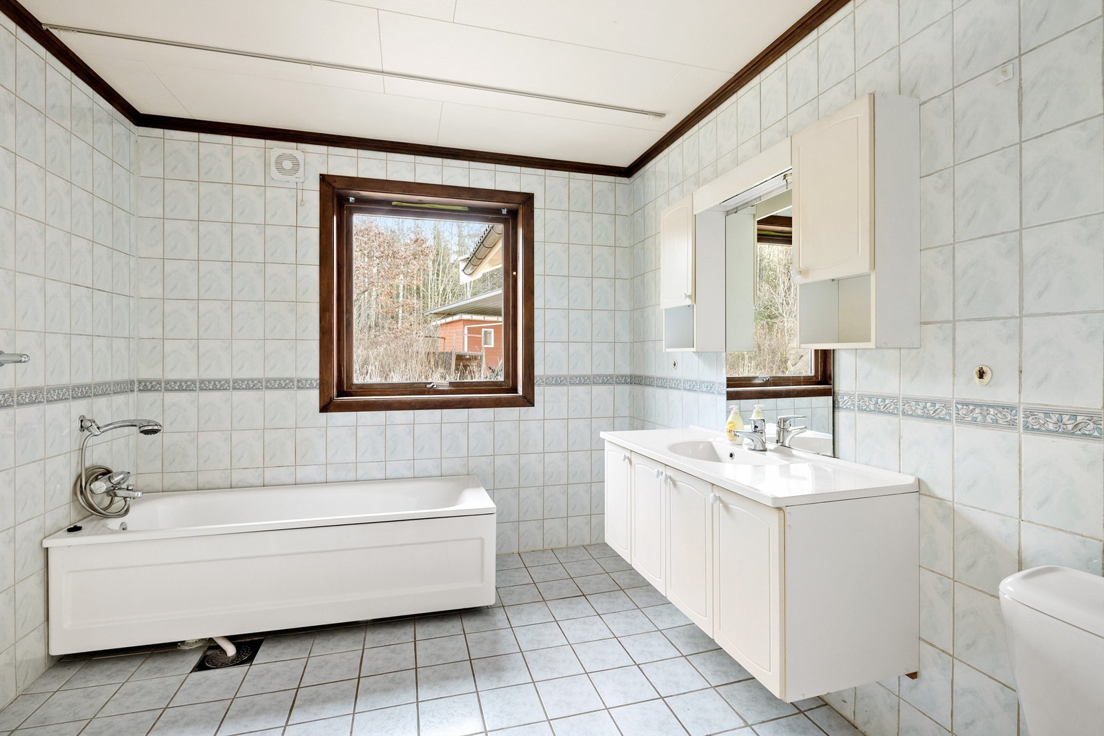 Innredet med servant, badekar, dusj og toalett. Galleribilde