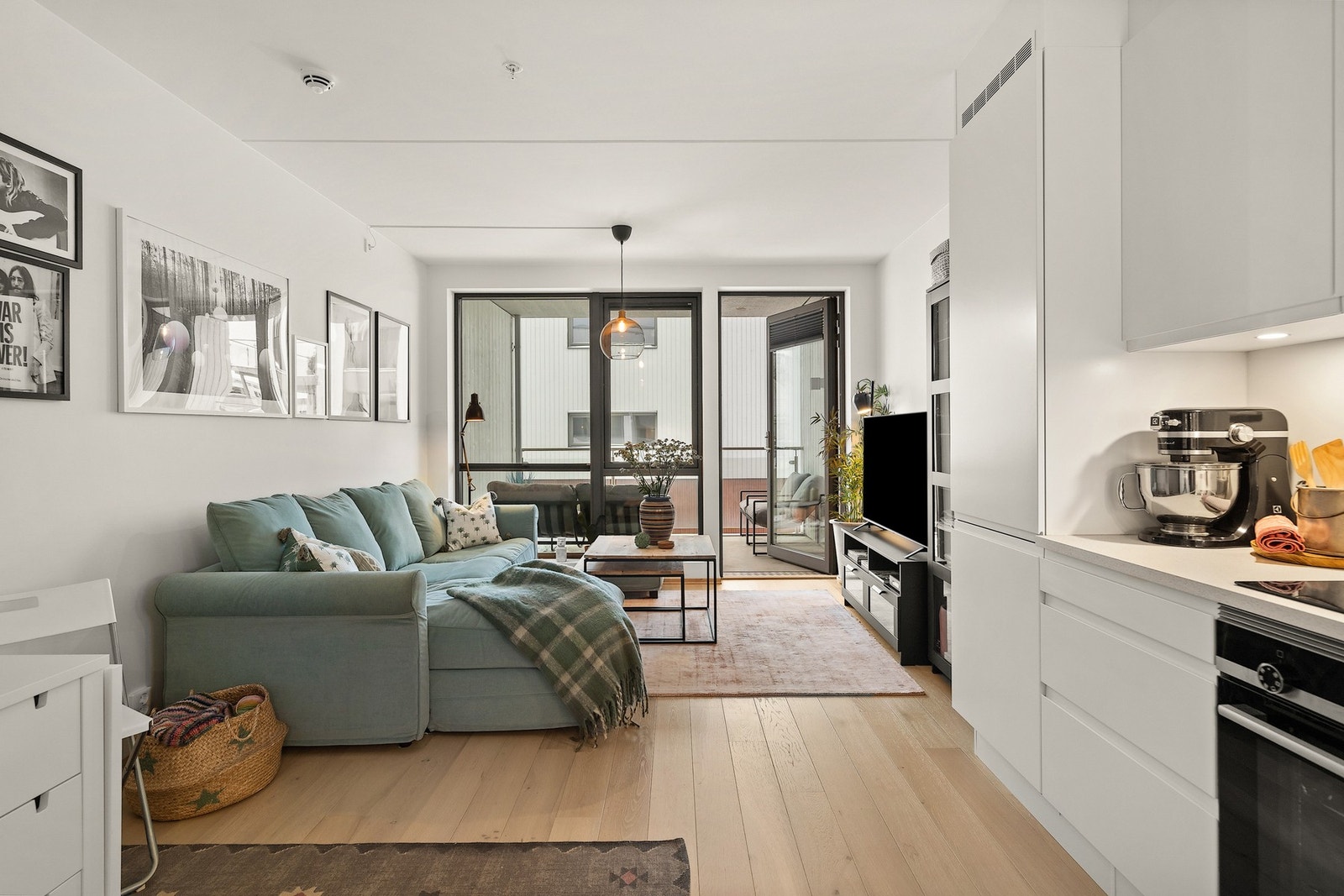 Oppholdsrommet er romslig og luftig, med en åpen løsning mellom stue og kjøkken som skaper en sosial og innbydende atmosfære. Galleribilde