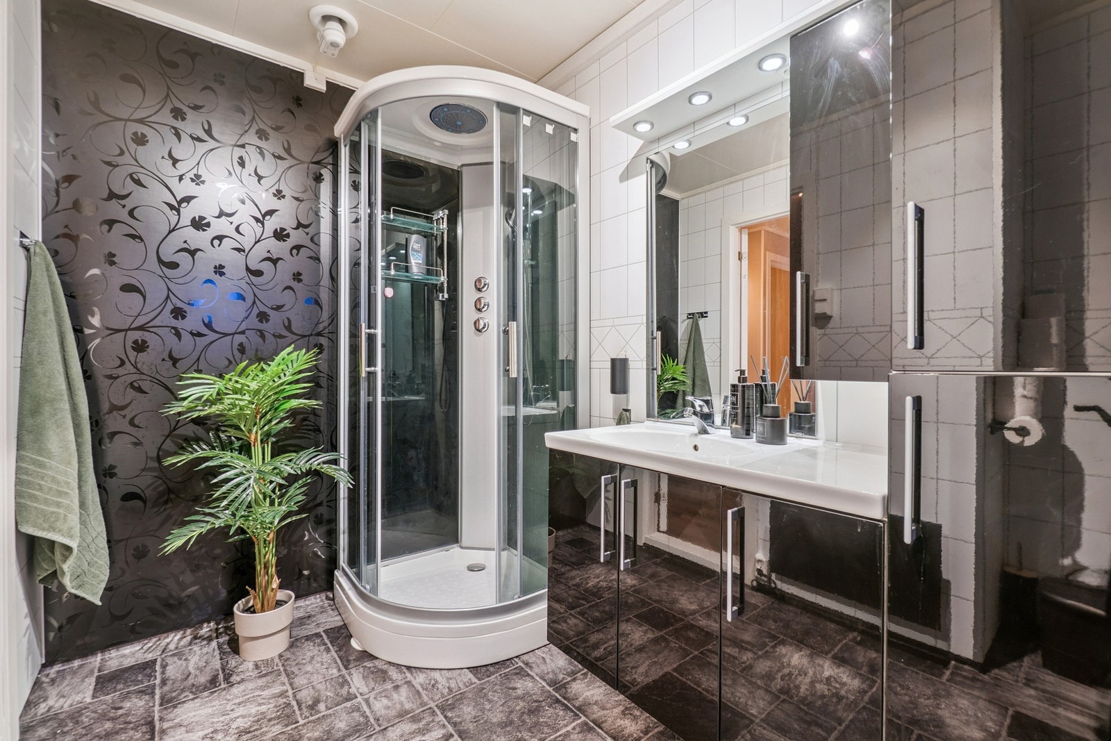 Badet har øvrig toalett, servant med god oppbevaringsplass i baderomsinnredningen, og dusjkabinett. Galleribilde