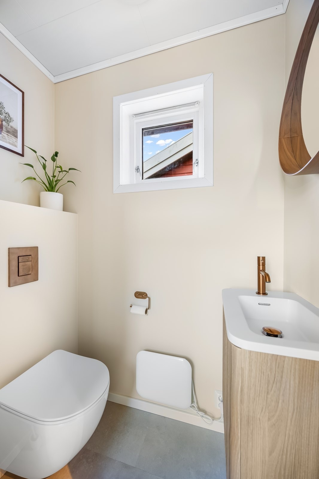 Toalettrom med vegghengt wc, vask i seksjon og speil. Pent modernisert i 2025 med fine farge og materialvalg. Galleribilde