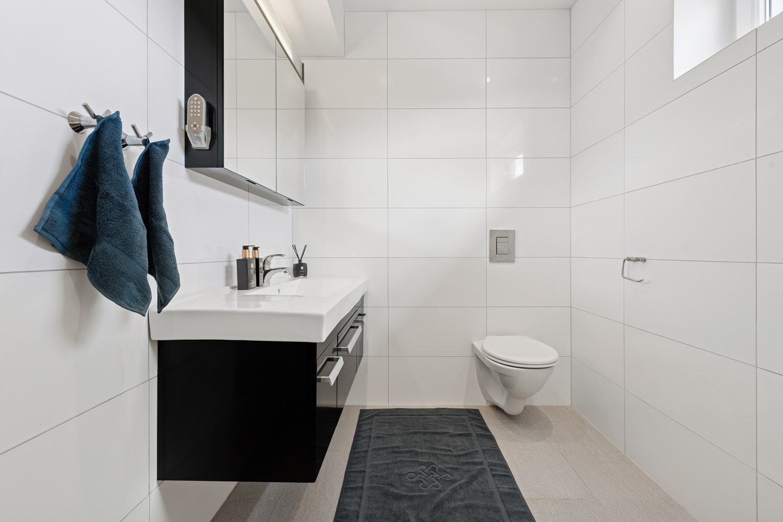 Badet er utstyr med toalett, dusj, baderomsinnredning med servant, speilskap, samt boblebadekar. Galleribilde