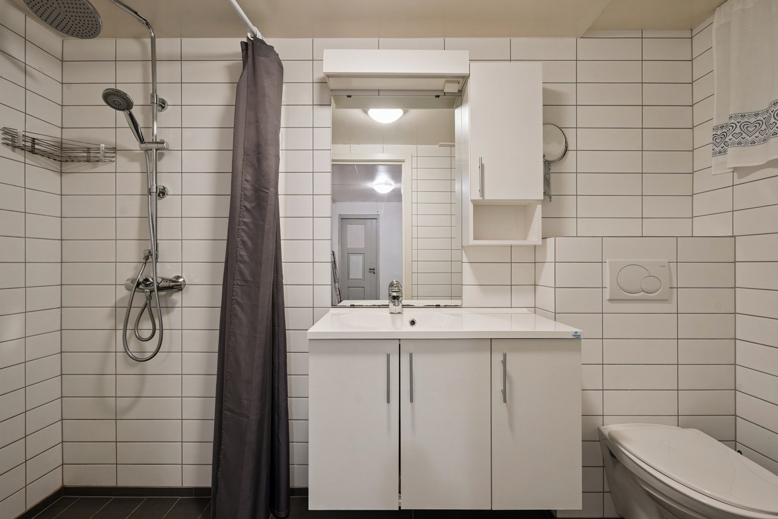 Bad med våtromsplater på vegger og fliser med elektriske varmekabler på gulvet. Galleribilde