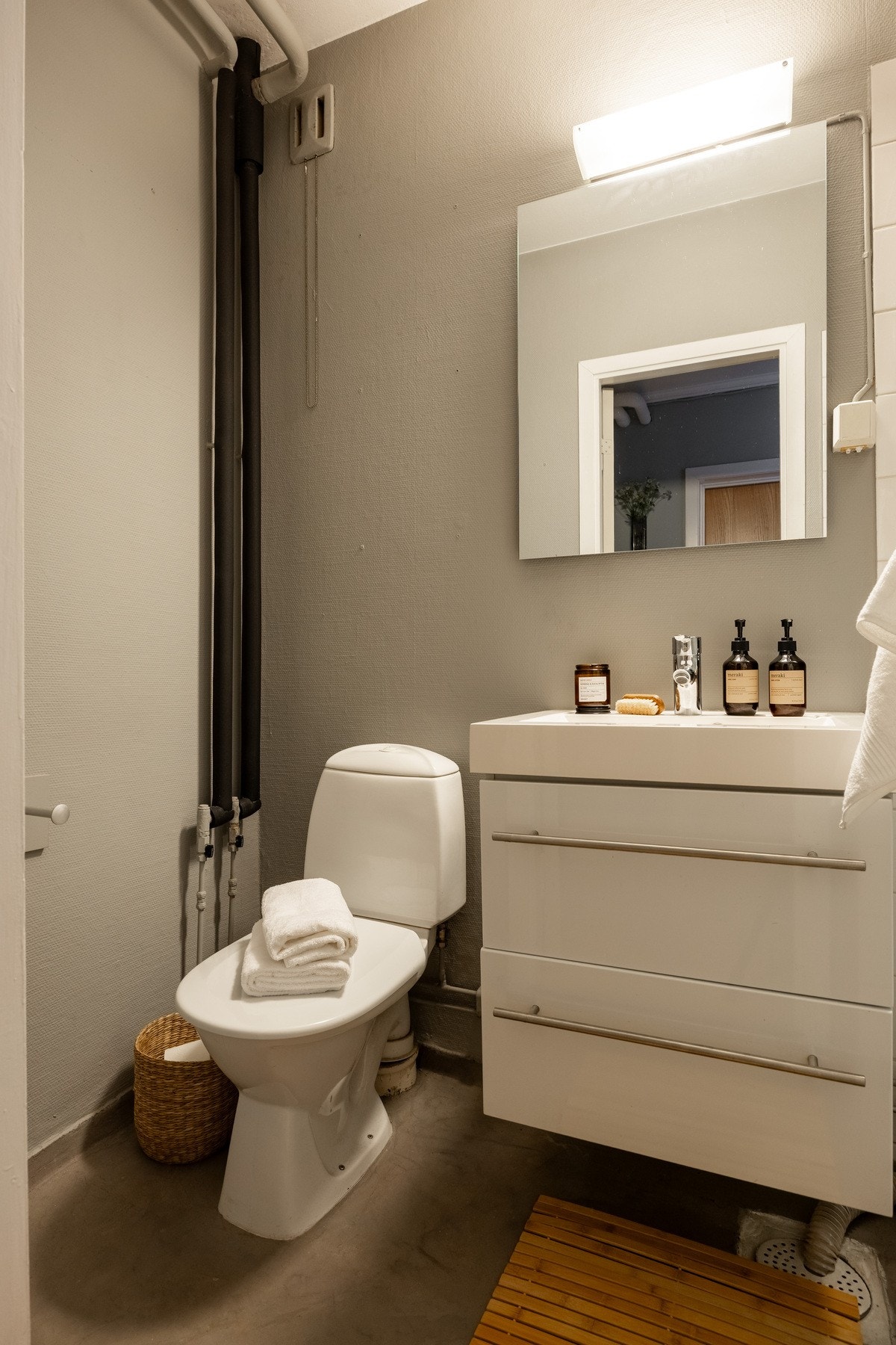 Baderom fra ukjent årstall med mikrosement på gulv og veggflater av malt betong. Galleribilde