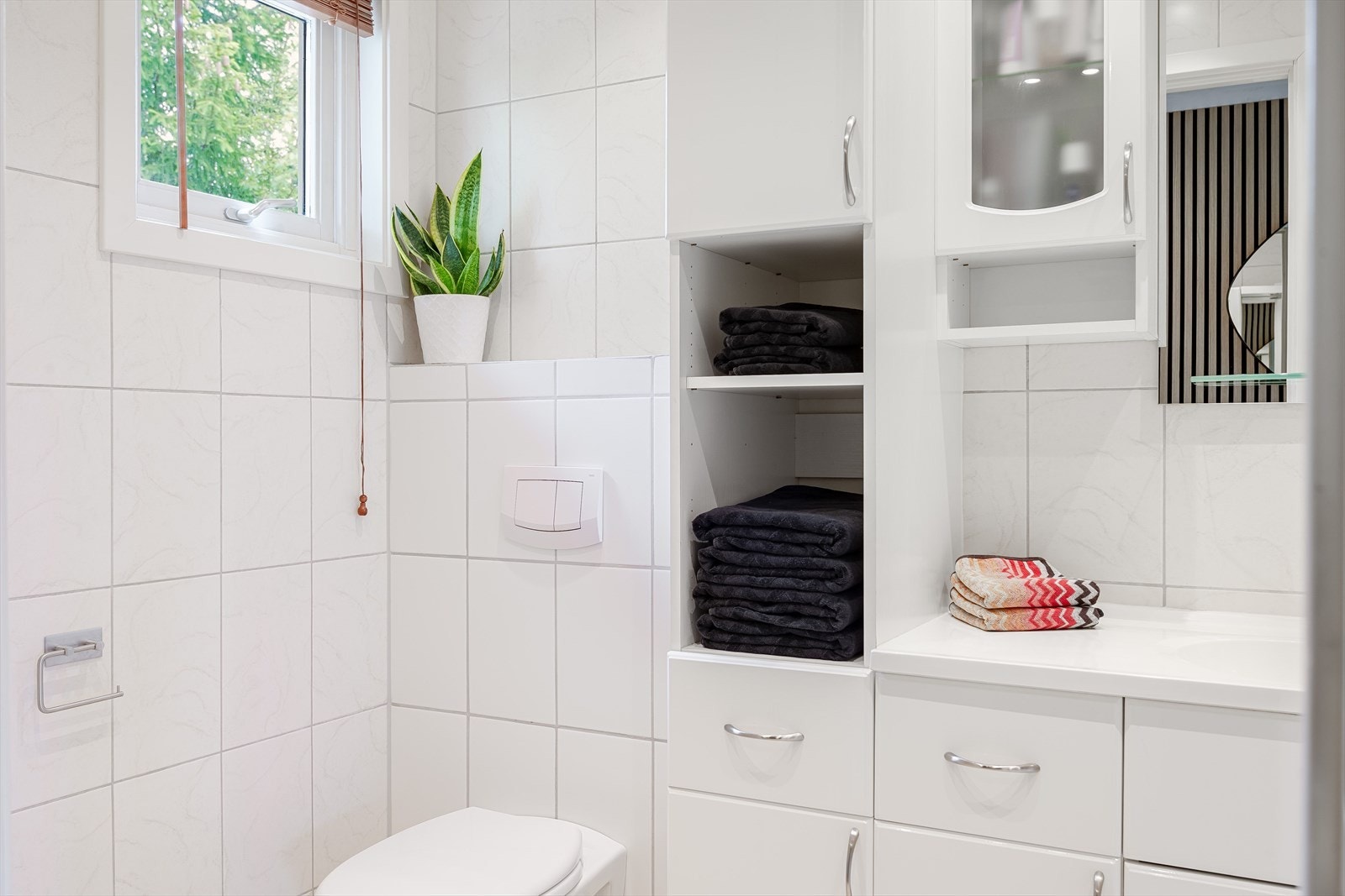 Baderommet er også utstyrt med vegghengt toalett og dusjhjørne med innfellbare glassdører. Galleribilde