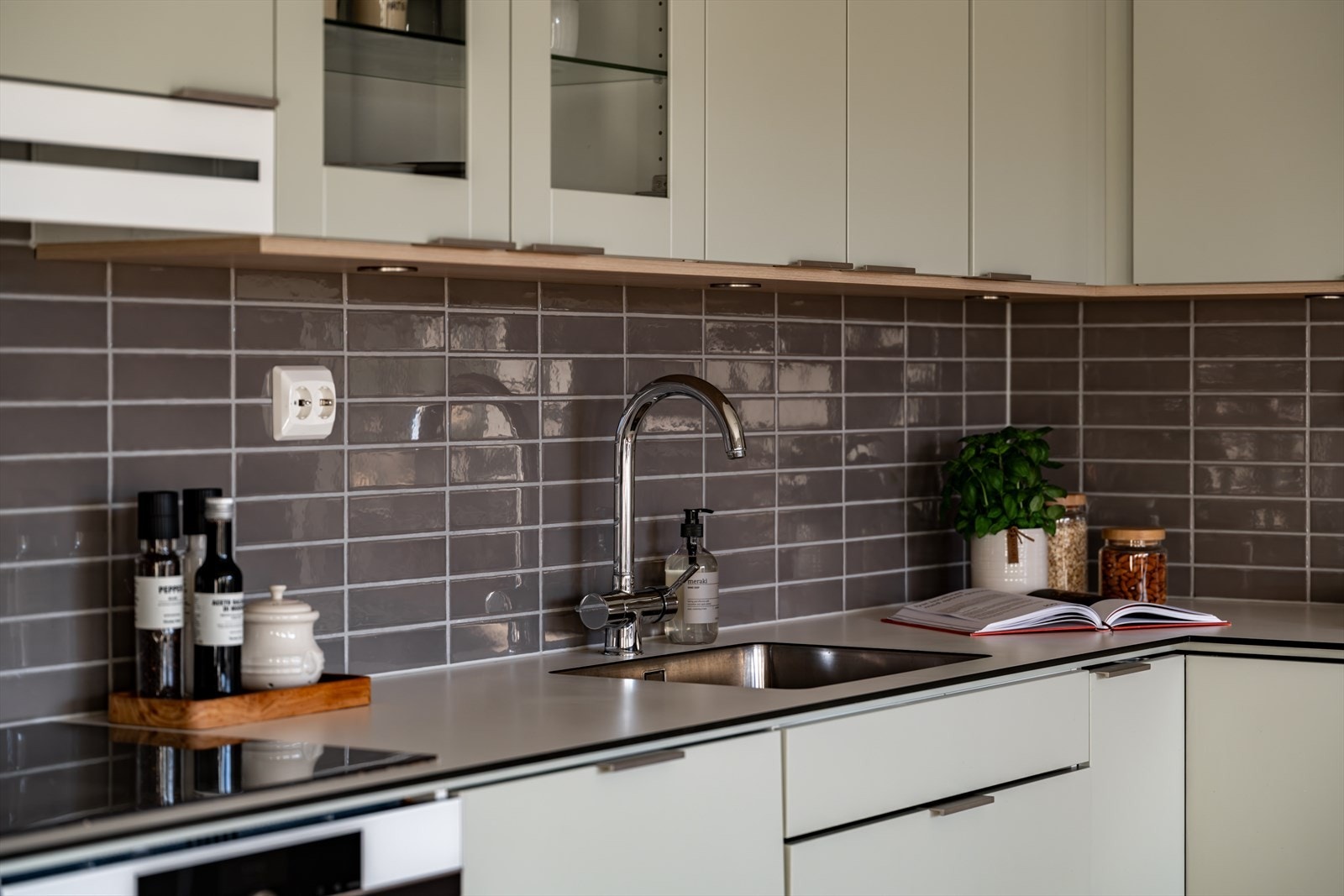 Pent kjøkken med glatte fronter i en nydelig dus grønntone. Galleribilde