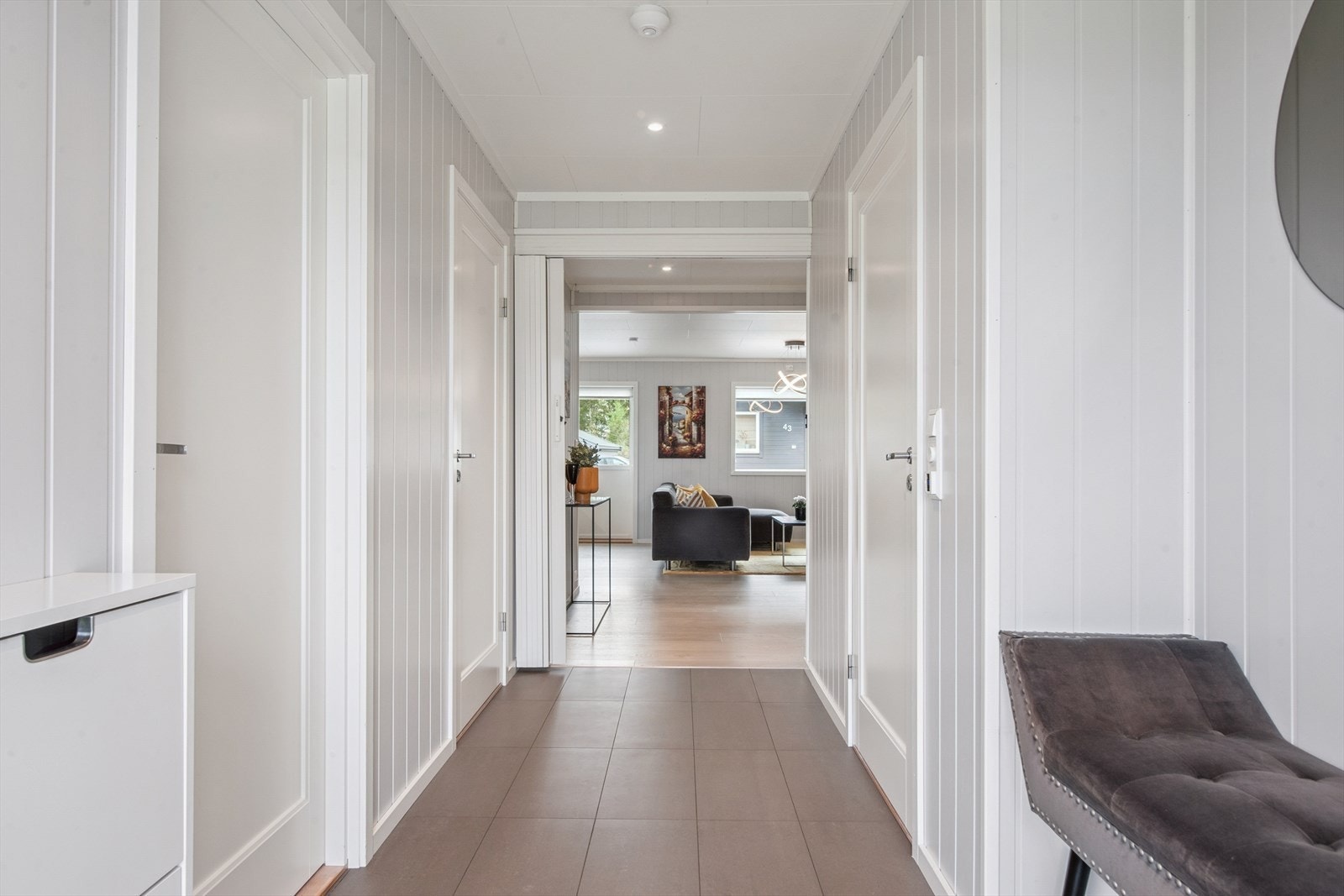 Velkommen inn i en lys entré med flislagt gulv og behagelig gulvvarme. Avsatt plass til garderobeløsning. Galleribilde