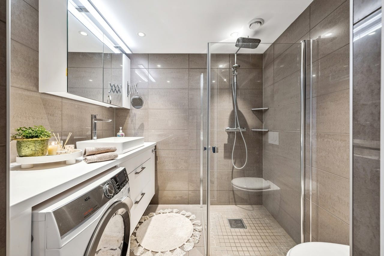 Leiligheten har 2 bad. Badet har fliser på gulv og på vegger. Praktisk innredning med avsatt plass til vaskemaskin. Galleribilde