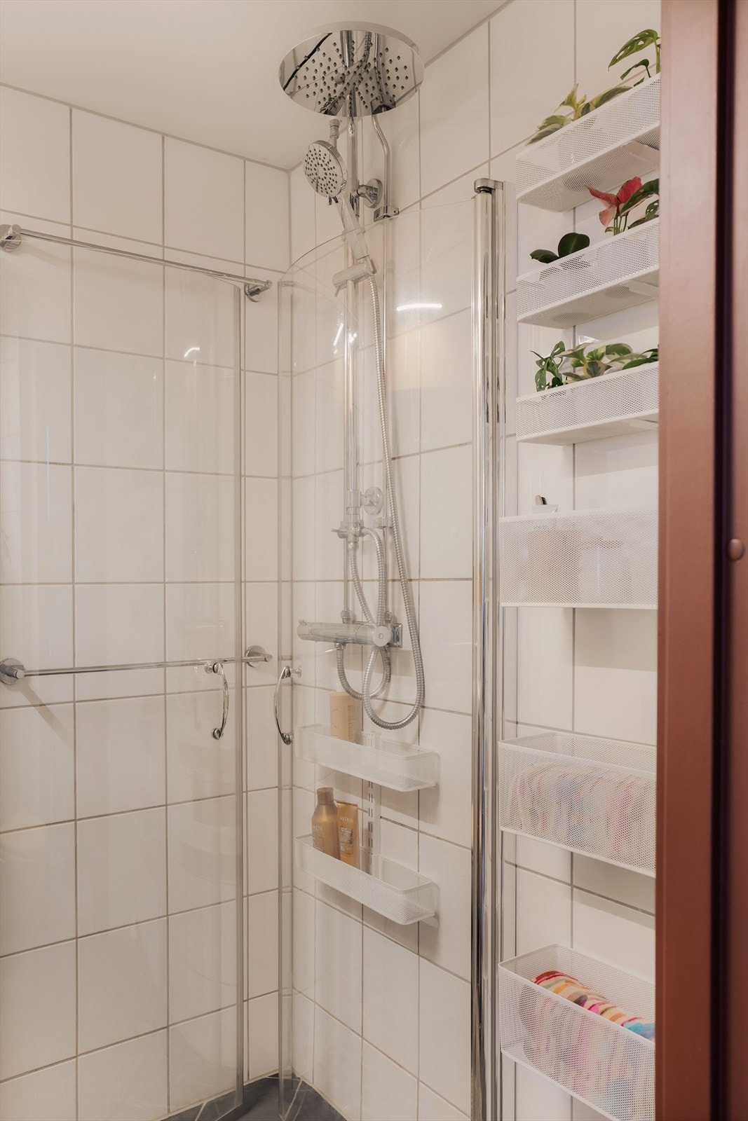 Badet har dusjhjørne med innfellbare glassdører og armatur som er tilkoblet hånd- og regndusj. Galleribilde