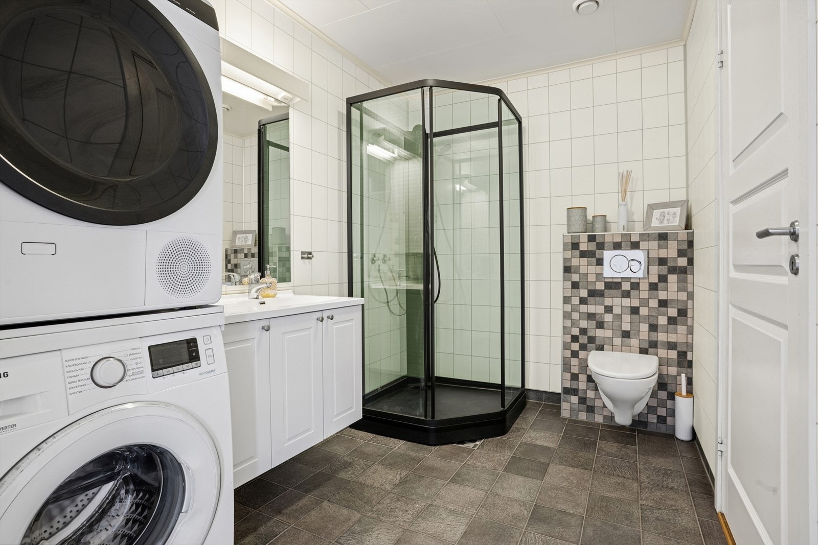 Baderommet har varmekabler i gulv, vegghengt klosett, dusjkabinett og nedfelt servant med skapløsning. Galleribilde