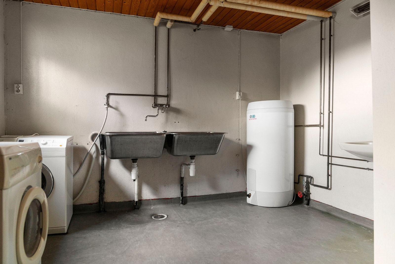 Praktisk vaskerom i boligens underetasje. Utstyrt med opplegg til vaskemaskin, utslagsvasker og varmtvannstank. Galleribilde