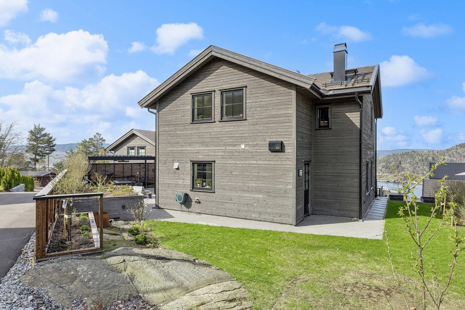 Uteområde er opparbeidet med hage, blomsterkasser, blomsterbed og trær. Galleribilde