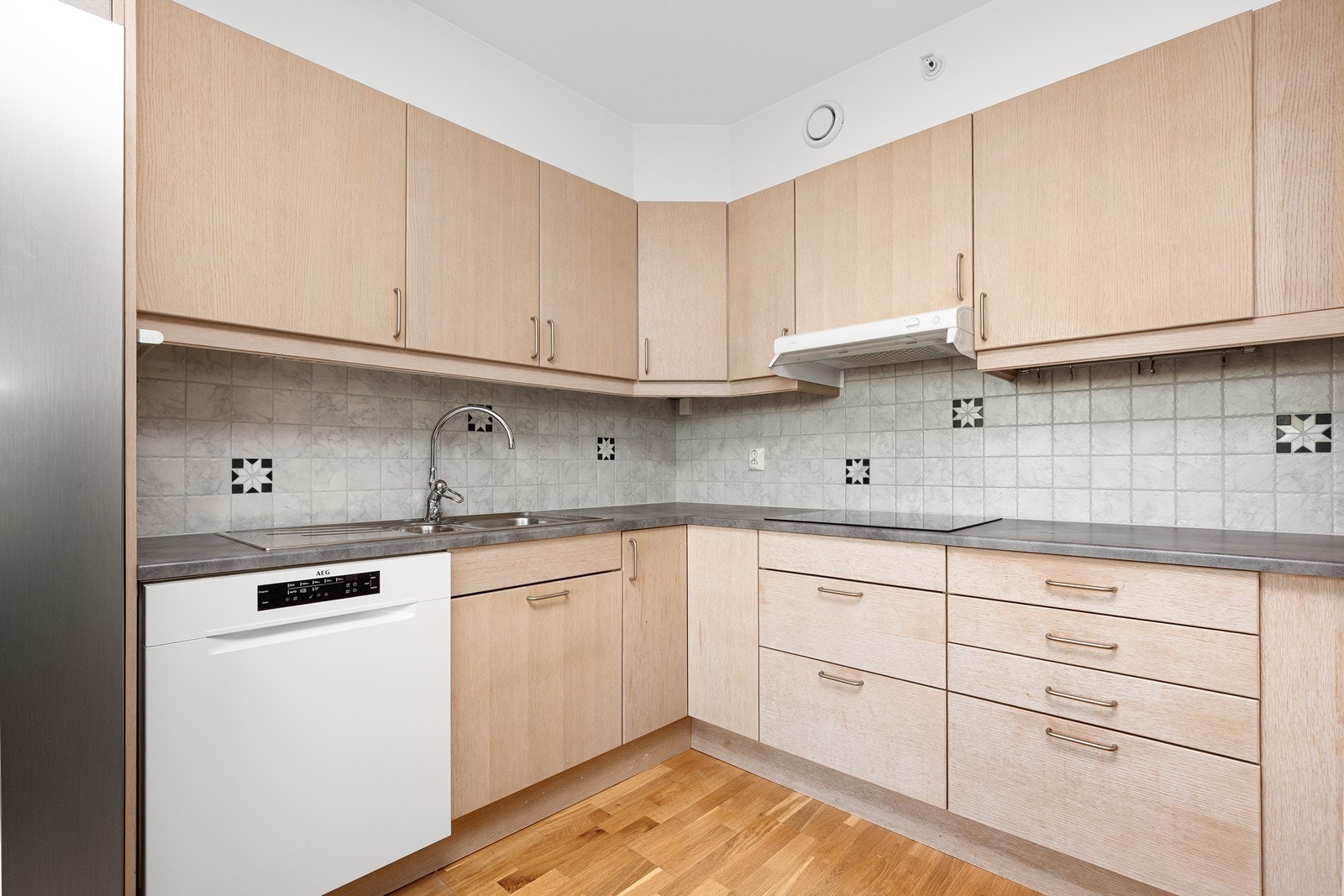 Kjøkkenet har lyse fronter og god benkeplass Galleribilde