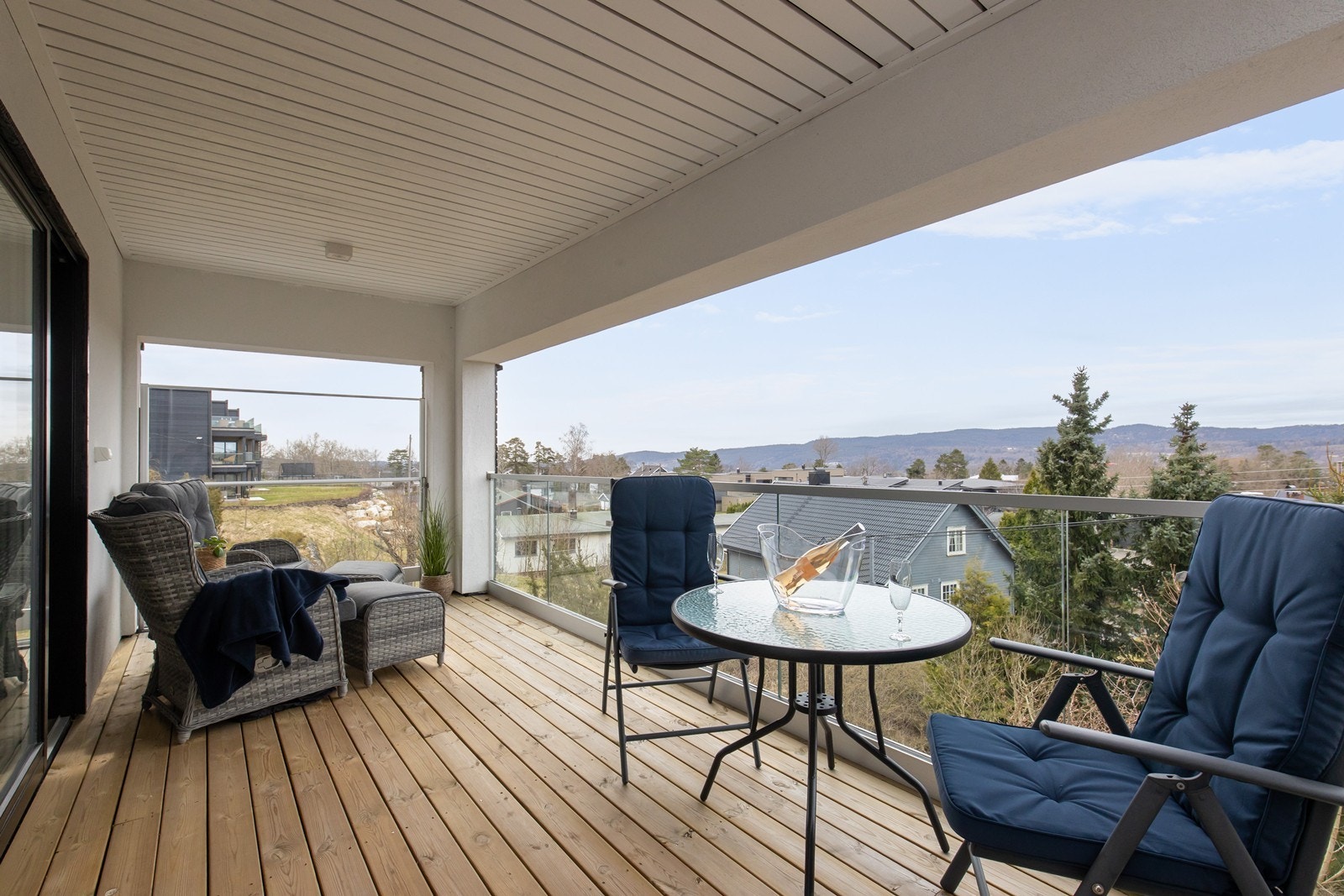 Overbygget terrasse med utgang fra stue - Hevbart glassrekkverk mot syd for vindskjerming. Galleribilde