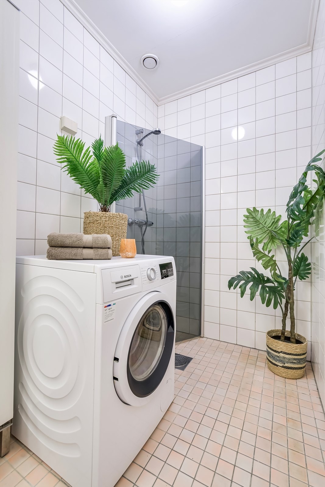 Badet inneholder vask, gulvstående toalett, dusjhjørne og opplegg for vaskemaskin. Galleribilde