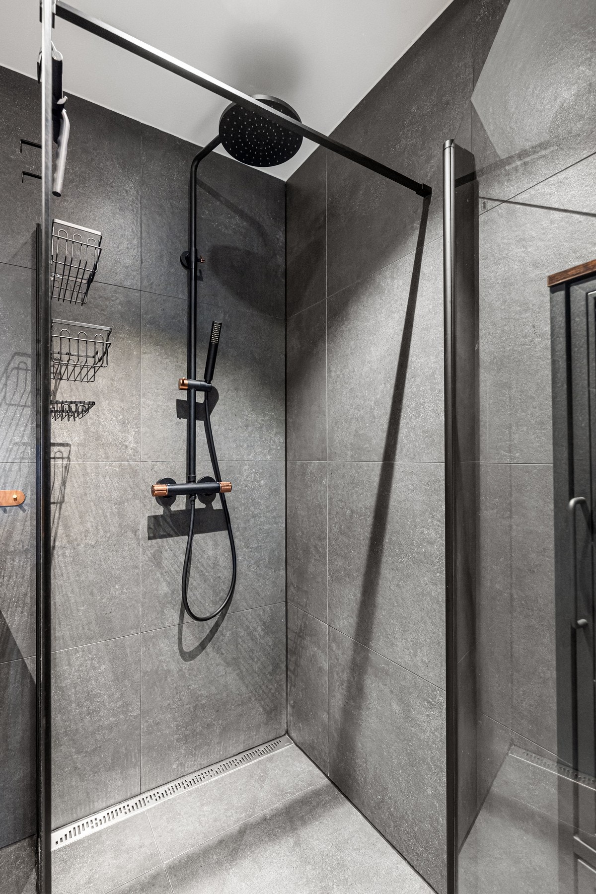 Dusjhjørne med glassdører og regnfallsdusj - både funksjonelt og elegant. Galleribilde