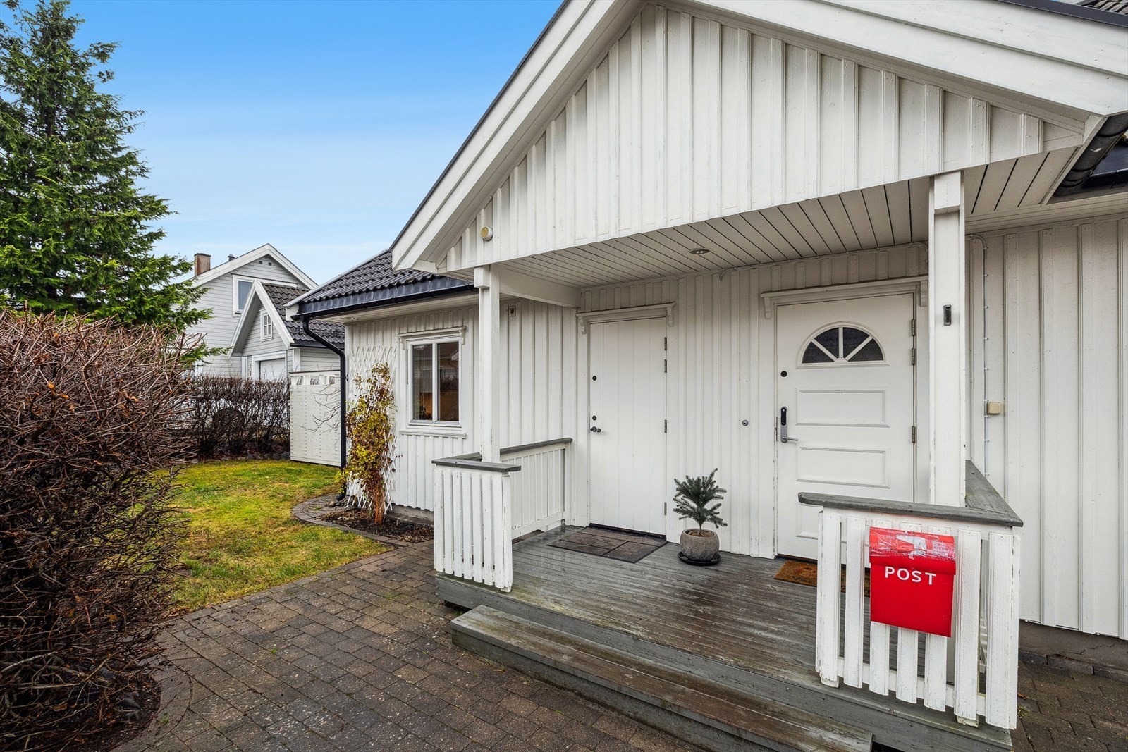 Overbygd inngangsparti. Her er det også direkte adkomst inn til boligens vaskerom. Kledning ble sist malt/beiser i 2020. Galleribilde