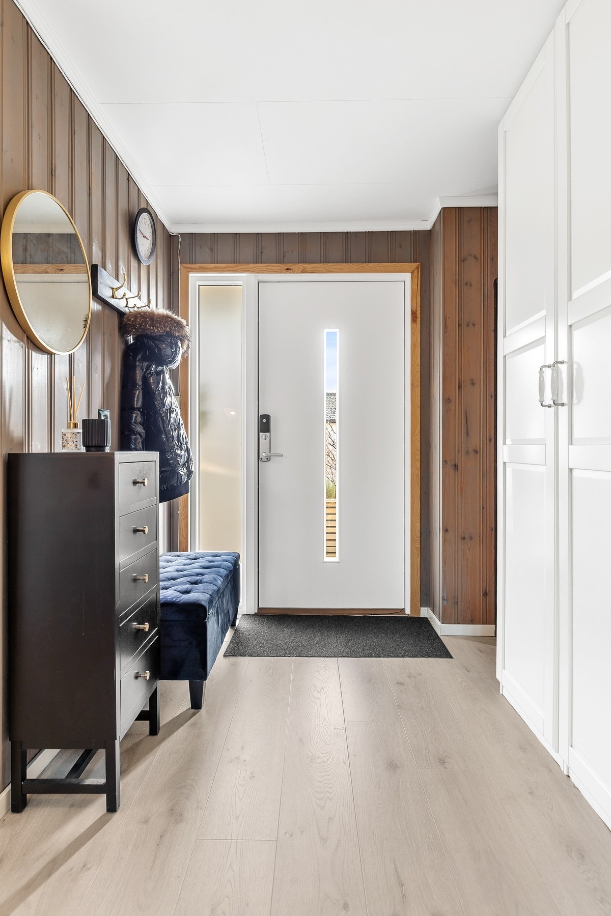 Romslig entré med nyere 1-stavs parkettgulv, panel på vegger og takplater i himling Galleribilde