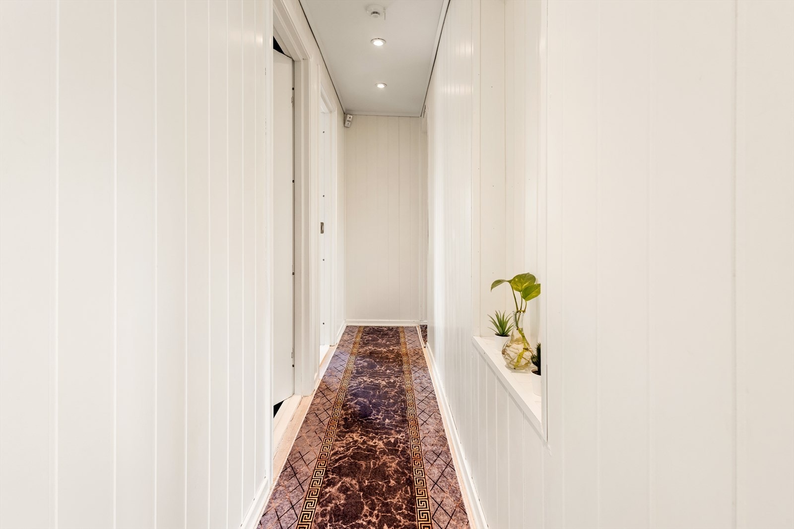 En lys og pen gang binder sammen soverommene og badet. Galleribilde