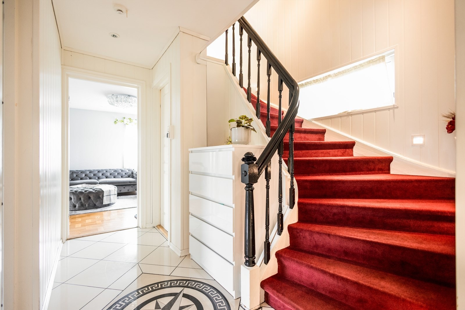 Fra entreen fører den teppelagte trappen fra byggeåret deg videre til boligens andre etasje. Galleribilde