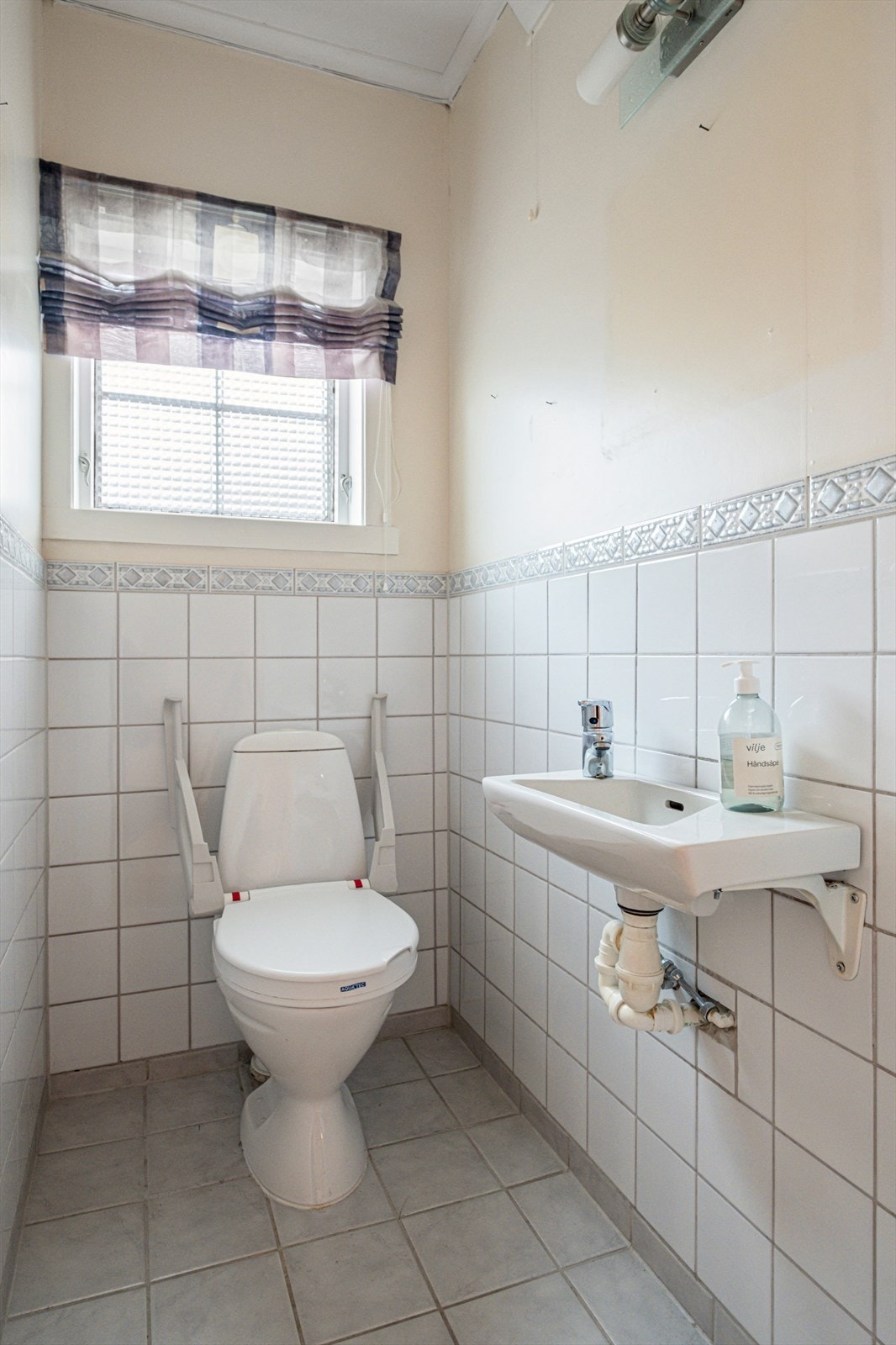 Flislagt toalettrom med naturlig avtrekk og vask gir enkel vedlikehold. Galleribilde