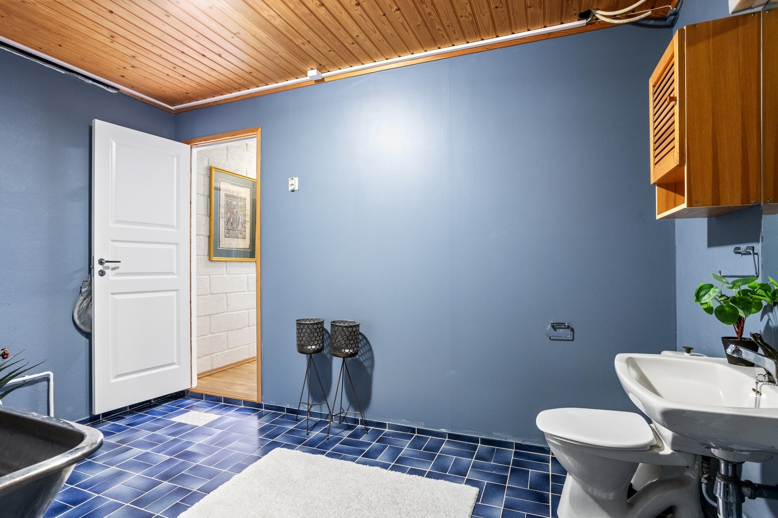 Sanitærutstyr bestående av toalett, servant, dusjhjørne med forheng, utslagsvask og røropplegg til vaskemaskin Galleribilde