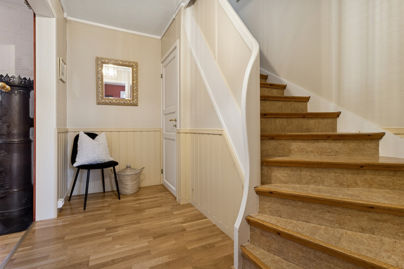 Fra entréen går du videre inn til en lys og romslig mellomgang med trapp som leder til boligens øvrige etasjer. Her går det også trapp ned til boligens kjeller. Galleribilde