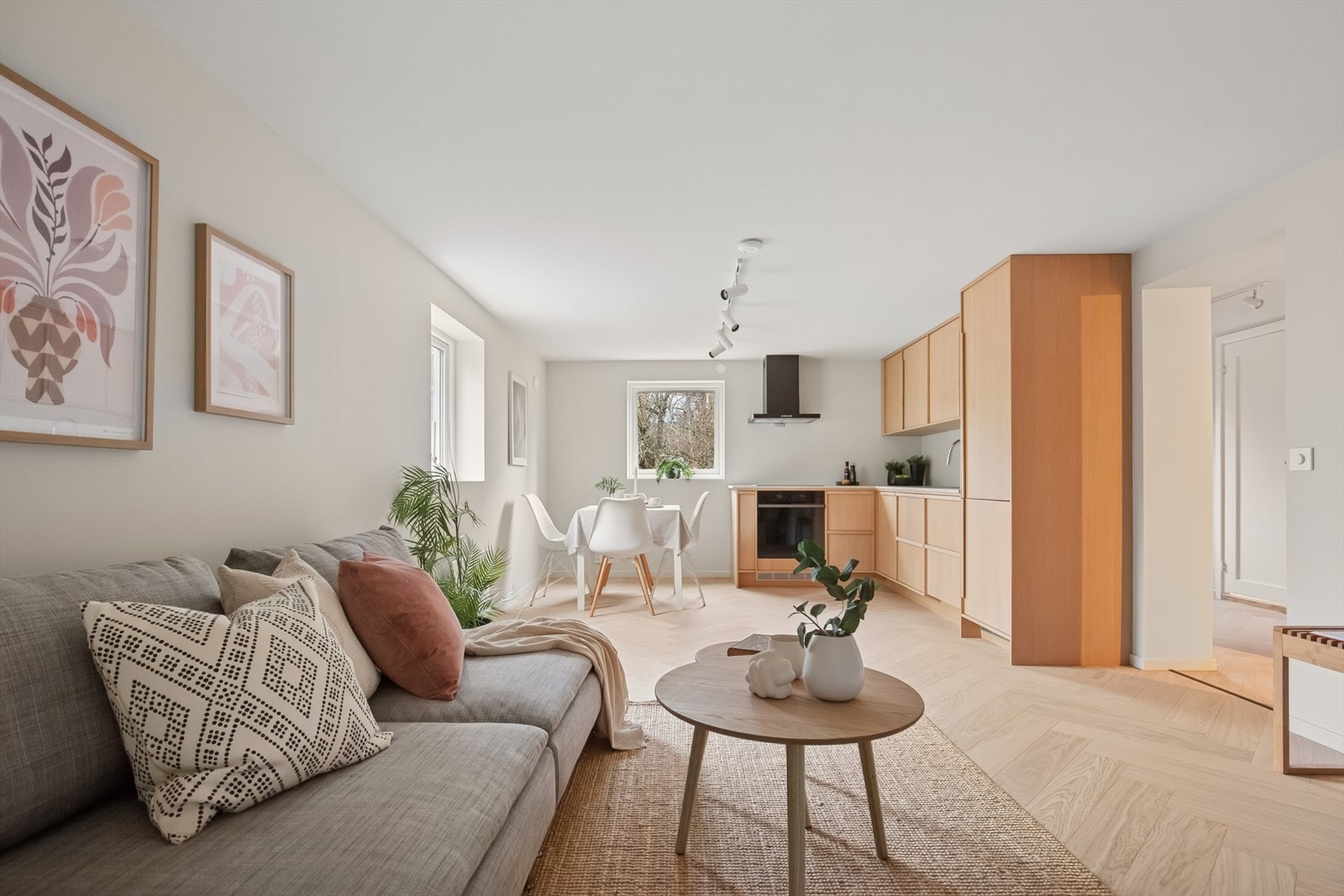 Kjøkkenet er en del av en åpen løsning med stue. Kjøkkeninnredning fra Elkjøp i 2025 med eikefargede fronter og laminat benkeplate. Galleribilde