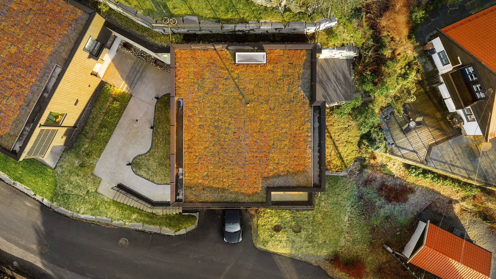 Tak lagt med Sedum og renner/nedløp i metall. Tomten har vakre natursteinsmurer i Alta-stein. Galleribilde