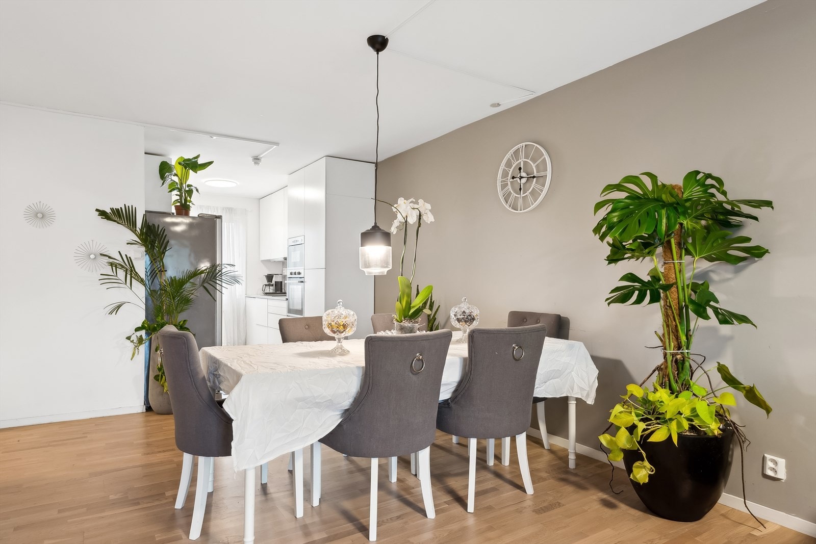 Stuen er et lyst allrom med naturlige møbleringssoner for både sofa og spisebord Galleribilde