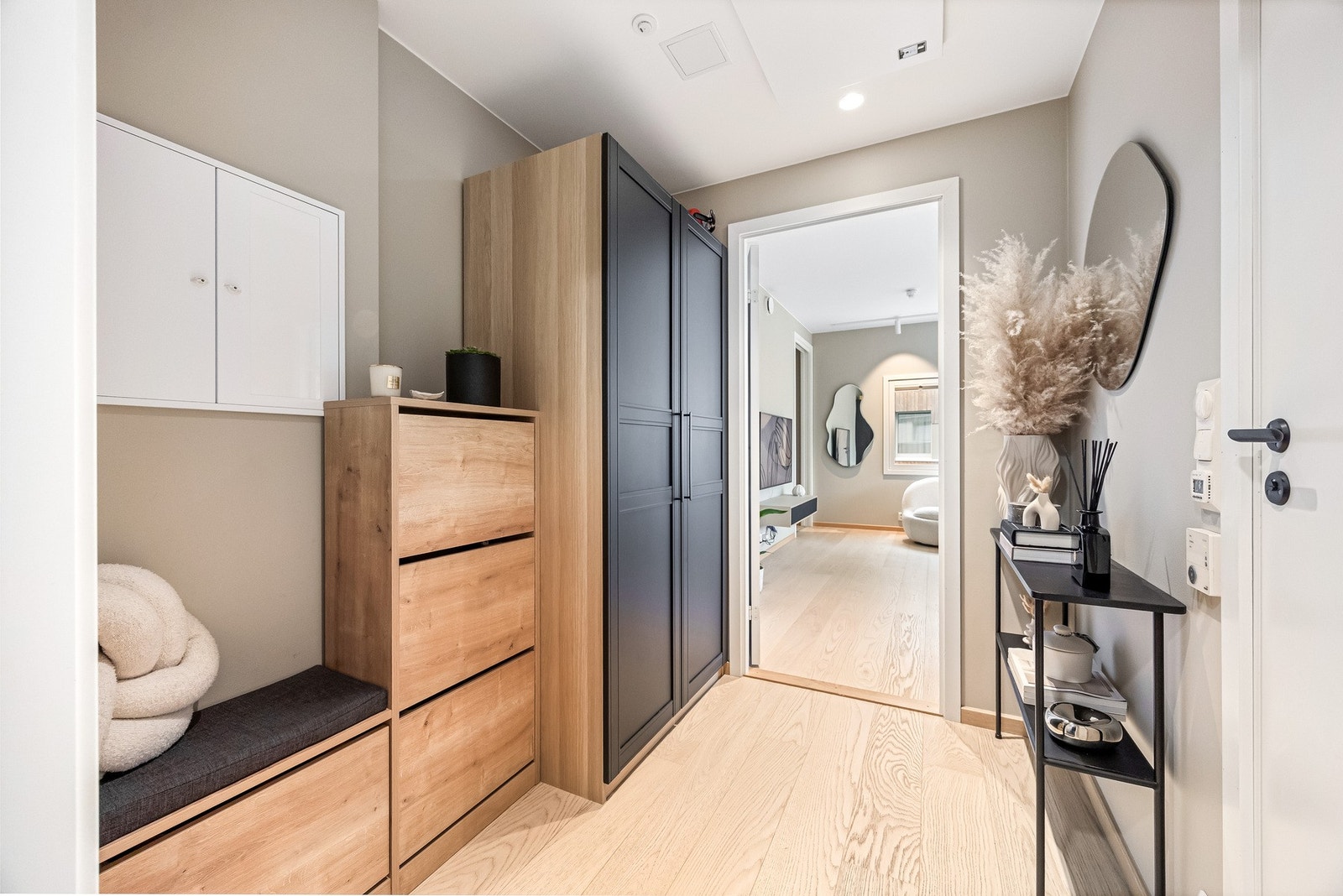 Innbydende gang med avsatt plass til skohylle, benk og garderobeskap. Galleribilde