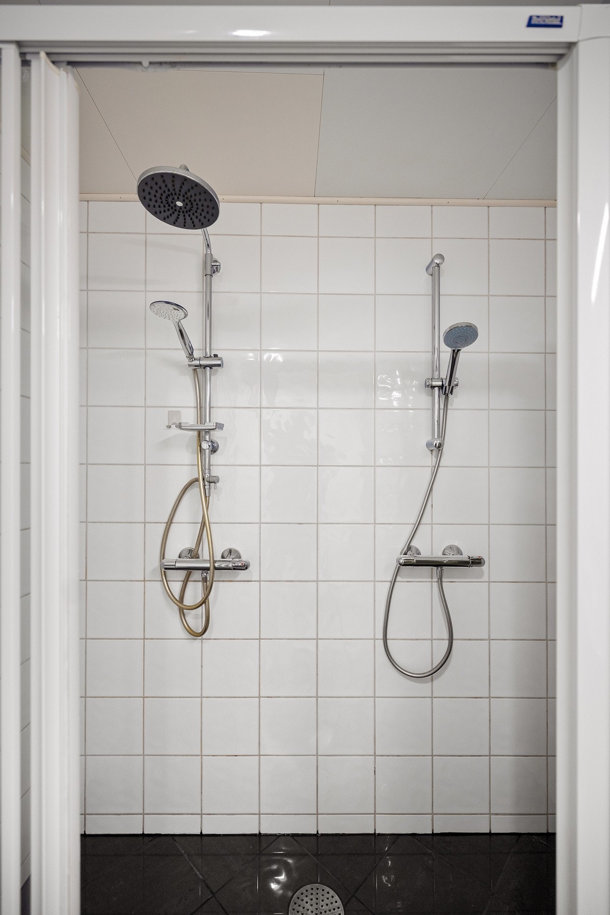 Badet har en romslig dusjsone med dører og skillevegg i glass, samt dobbeldusj Galleribilde