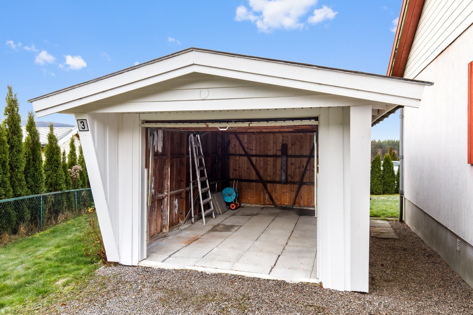 Enkelgarasje plassert på kortsiden av boligen Galleribilde