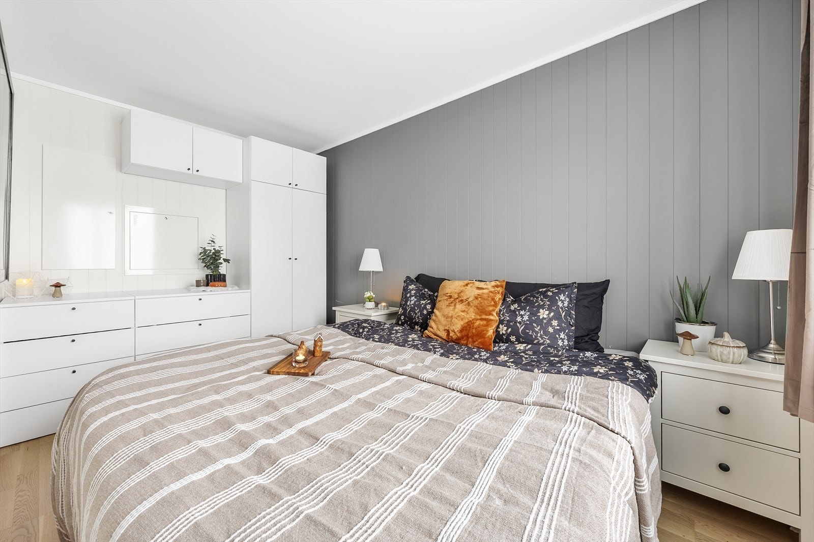 Langs den ene veggen er det en smart garderobeløsning med skuffer og skap. Galleribilde