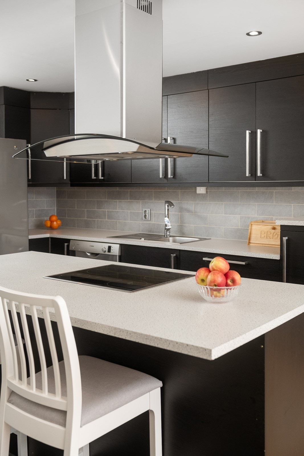 Kjøkkenøya har rikelig med arbeidsflate og en ventilatorhette i stål. Galleribilde